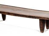a small wooden bench that is sitting on a white surface