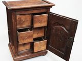 a small wooden cabinet with drawers inside of it