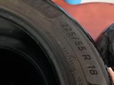 someone is holding a tire tire in front of a wall