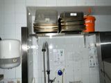 a kitchen with a sink and a lot of dishes on the counter