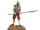statue d'un homme muni d'une lance et d'un bouclier, posée sur un socle en bois
