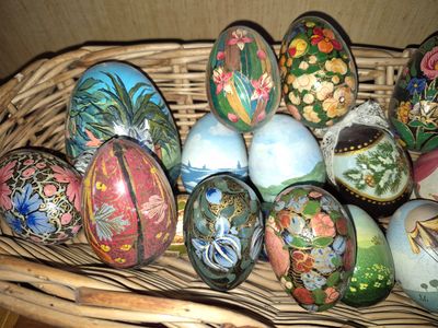 a basket full of painted easter eggs sitting on a table