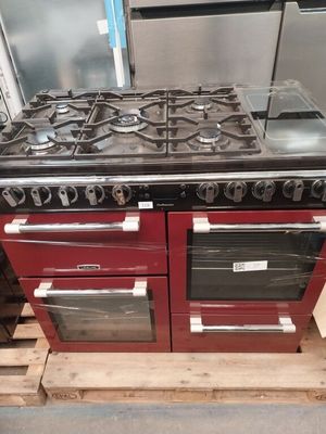 un poêle rouge et noir avec deux fours, posé sur une palette