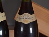 two bottles of wine that are sitting on a table