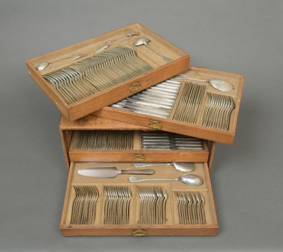 two wooden boxes with silverware in them on a gray surface