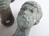 a statue of a head and a vase on a table