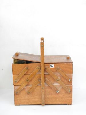 une petite boîte en bois munie d'une poignée en bois