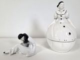 porcelain figurines of a woman in a dress and a man in a tuxedo sitting next to each other