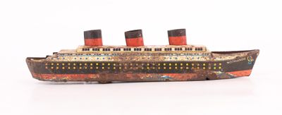 a wooden model of a ship on a white surface