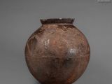 a brown vase that is sitting on a table