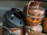 many pots and pans on a shelf in the kitchen