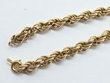 a pair of gold chain bracelets on a white background