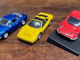 trois petites voitures posées sur une table en bois