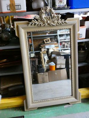 a mirror that is sitting on a shelf in a room