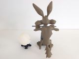 a toy rabbit and an egg sitting next to each other