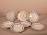 six blue and white china plates and a bowl on a table