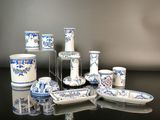 many blue and white dishes and cups on the table