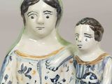 a figurine of a woman and a child holding a basket