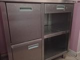 a stainless steel cabinet with two drawers and a door