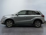 the silver suv is parked in a room with a white wall
