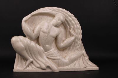 statue of a woman holding a bird in her hands