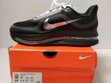 a pair of black and white shoes on top of an orange box