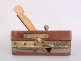 a small wooden plane that is sitting on a table