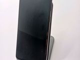 an image of a black phone is sitting on top of a stand