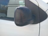 reflection of a car ' s side view mirror on the side of a white car