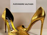 a close up of a pair of gold shoes on a table