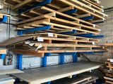 many pallets of wood stacked on the shelves in the warehouse