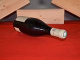 a bottle of wine sitting on a red table cloth