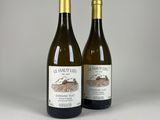 two bottles of wine sitting next to each other on a table