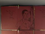four red books with drawings of a man and a woman on them
