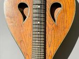 a wooden heart shaped instrument hanging on the wall