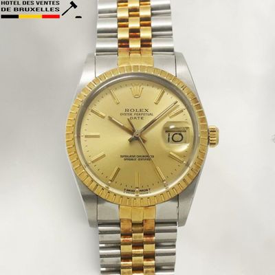 an image of a gold and silver rolex watch on a white background
