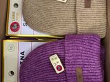 purple and beige knitted beanies in a cardboard box