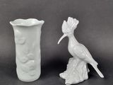 two white vases sitting next to each other on a table
