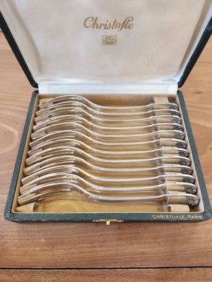 a lot of spoons in a case on a table