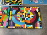 several pieces of art are on display on the floor