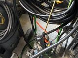 a pile of hoses and other equipment in a garage