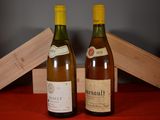 two bottles of wine sitting next to each other on a table