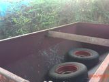 two tires in the bottom of a dumpster
