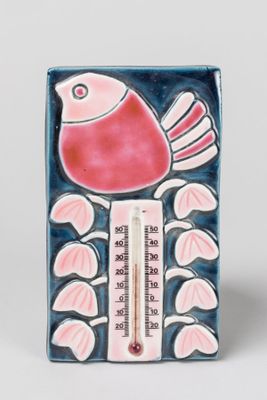 a ceramic thermometer with a bird on it