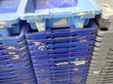 several blue plastic containers stacked on top of each other on a pallet