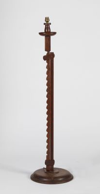 an image of a wooden candle holder with a candle on it