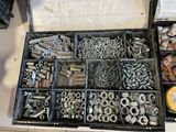 many different types of nuts and screws in a box