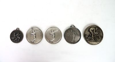 four medals of different sizes and shapes are shown on a white surface