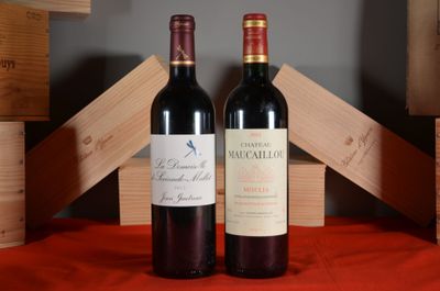two bottles of red wine sitting next to each other on a table