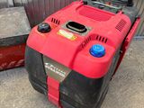 a red and black lawn mower sitting on the sidewalk